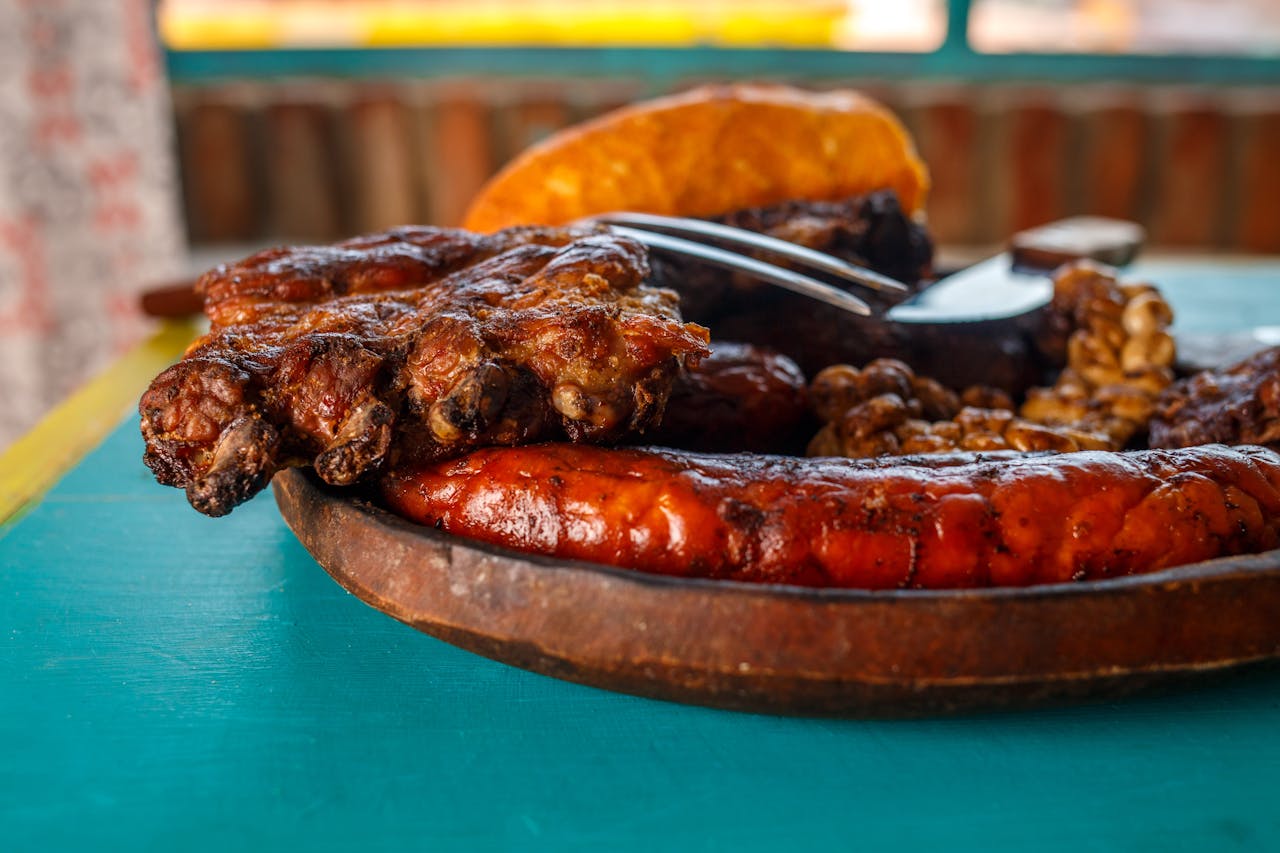 A mouthwatering close-up of traditional Argentine BBQ featuring sausages and grilled meats on a wooden platter.